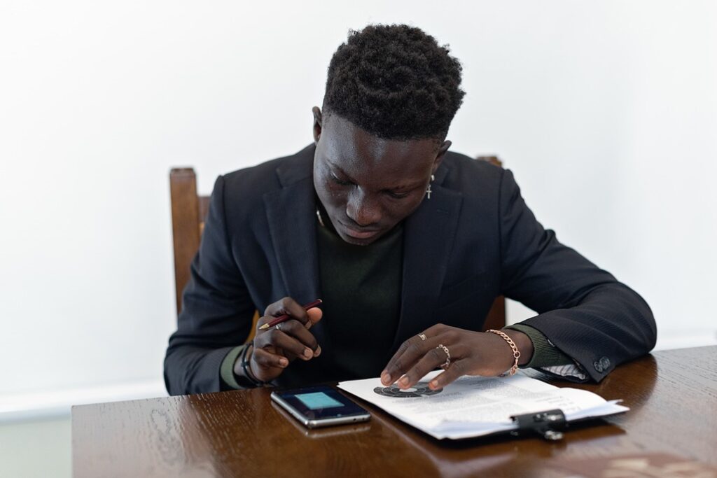 A man in a gray suit faxing Form 8822-B to the IRS.